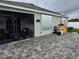 Outdoor patio with hurricane shutters and a grilling area at 2201 Grand Flora Trl, Bradenton, FL 34208