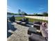 Spacious backyard patio with comfortable seating and a large grassy area at 2201 Grand Flora Trl, Bradenton, FL 34208