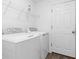 Bright laundry room with washer, dryer, and shelving at 2288 Barrister St, North Port, FL 34288