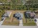 Aerial view of three single-Gathering homes in a residential neighborhood at 2364 Hagerick Ln, North Port, FL 34288