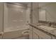 Updated bathroom features a granite countertop and shower-tub combination at 2364 Hagerick Ln, North Port, FL 34288