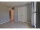 Bedroom with spacious closet, neutral paint, and tile flooring, offering a serene and tidy retreat at 2364 Hagerick Ln, North Port, FL 34288