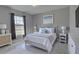 Airy bedroom showcasing neutral walls, tile floors, and a large window at 2364 Hagerick Ln, North Port, FL 34288