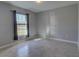 Well-lit bedroom with tile flooring and window at 2364 Hagerick Ln, North Port, FL 34288