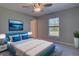 Bright bedroom featuring a large window, ceiling fan, and modern decor at 2364 Hagerick Ln, North Port, FL 34288