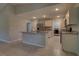 The kitchen features a view into the laundry room, an island, and stainless steel appliances at 2364 Hagerick Ln, North Port, FL 34288