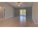 Spacious living room with tile floors and sliding glass doors to the outdoor patio at 2364 Hagerick Ln, North Port, FL 34288
