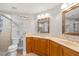 Double vanity bathroom with wood cabinets and a large mirror at 240 W End Dr # 311, Punta Gorda, FL 33950