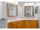 Bathroom featuring a double vanity with wood cabinets and updated lighting at 240 W End Dr # 311, Punta Gorda, FL 33950
