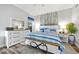 Main bedroom with a king-size bed, a ceiling fan, and a leafy wall accent at 240 W End Dr # 311, Punta Gorda, FL 33950