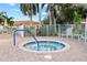 Community hot tub area with surrounding lounge chairs at 240 W End Dr # 311, Punta Gorda, FL 33950
