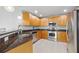 Modern kitchen featuring stainless steel appliances and dark granite countertops at 240 W End Dr # 311, Punta Gorda, FL 33950