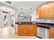 Kitchen with granite countertops, wood cabinets, and a view into the living area at 240 W End Dr # 311, Punta Gorda, FL 33950