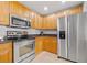 Stainless steel appliances and wood cabinets in this well-lit kitchen at 240 W End Dr # 311, Punta Gorda, FL 33950