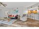 Bright living room with hardwood floors, comfy seating, and a view into the kitchen at 240 W End Dr # 311, Punta Gorda, FL 33950
