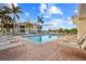 Community pool area with lounge chairs and a screened-in pavilion at 240 W End Dr # 311, Punta Gorda, FL 33950