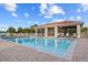 Community pool area with lounge chairs and a screened-in pavilion at 240 W End Dr # 311, Punta Gorda, FL 33950