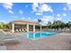 Community pool area with lounge chairs and a screened-in pavilion at 240 W End Dr # 311, Punta Gorda, FL 33950