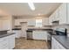 Modern kitchen with white cabinets and stainless steel appliances at 2410 Lanier Rd, Punta Gorda, FL 33982