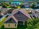 Back of house with a large yard and partial view of a lake at 2507 Hobblebrush Dr, North Port, FL 34289