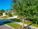 House with lush green landscaping and a tree in the front yard at 2507 Hobblebrush Dr, North Port, FL 34289