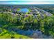 Aerial view of a house nestled in a community by a lake at 2507 Hobblebrush Dr, North Port, FL 34289