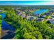 Aerial view of houses, lake and lush green landscape at 2507 Hobblebrush Dr, North Port, FL 34289