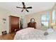 Bedroom featuring floral bedding, ceiling fan, and ample closet space at 2507 Hobblebrush Dr, North Port, FL 34289