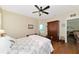 Bedroom with floral bedding, en-suite bathroom access, and wood floors at 2507 Hobblebrush Dr, North Port, FL 34289