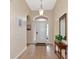 Bright and airy foyer with tile flooring and a wooden console table at 2507 Hobblebrush Dr, North Port, FL 34289
