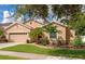 Single-story house with beige exterior, palm trees, and a well-manicured lawn at 2507 Hobblebrush Dr, North Port, FL 34289