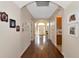 Long hallway with hardwood floors, arched doorways, and Gathering photos at 2507 Hobblebrush Dr, North Port, FL 34289