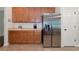Kitchen with stainless steel refrigerator and wood cabinets at 2507 Hobblebrush Dr, North Port, FL 34289