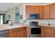 Kitchen boasts stainless steel appliances and ample wood cabinetry at 2507 Hobblebrush Dr, North Port, FL 34289