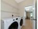Laundry room with washer, dryer, and access to dining room at 2507 Hobblebrush Dr, North Port, FL 34289