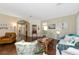 Comfortable living room featuring hardwood floors, a neutral color palette, and comfy seating at 2507 Hobblebrush Dr, North Port, FL 34289