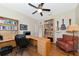 Home office with large desk, built-in shelving, and comfortable armchair at 2507 Hobblebrush Dr, North Port, FL 34289