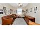 Home office with hardwood floors, leather armchairs, and ample natural light at 2507 Hobblebrush Dr, North Port, FL 34289