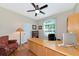 Home office with large desk, built-in shelving, and comfortable armchair at 2507 Hobblebrush Dr, North Port, FL 34289