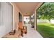 Screened porch with backyard view and wooden chairs at 2507 Hobblebrush Dr, North Port, FL 34289