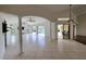 Bright living room with tile floors and sliding doors to screened pool area at 264 Rotonda N Blvd, Rotonda West, FL 33947