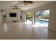 Spacious living room featuring tile floors, ceiling fans and access to the lanai at 264 Rotonda N Blvd, Rotonda West, FL 33947