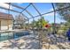 A screened-in pool area with outdoor seating and landscaping in the backyard at 264 Rotonda N Blvd, Rotonda West, FL 33947