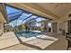 Inviting screened-in pool area with a hot tub, seating and bar area perfect for outdoor relaxation at 264 Rotonda N Blvd, Rotonda West, FL 33947