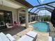 Inviting pool area with screened enclosure and lounge chairs at 283 White Marsh Ln, Rotonda West, FL 33947