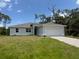 Charming single-story home with a manicured lawn and attached two-car garage at 290 Overbrook St, Port Charlotte, FL 33954