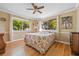 Bedroom with hardwood floors, a ceiling fan, and ample natural light at 3026 Guadalupe Dr, Punta Gorda, FL 33950