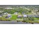Aerial view of home with backyard, pool, and canal-front lot in a residential neighborhood at 31 Tee View Pl, Rotonda West, FL 33947