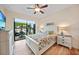 Guest bedroom with white wooden frame bed and sliding doors to the patio at 31 Tee View Pl, Rotonda West, FL 33947