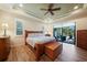 Main bedroom with wood flooring and sliding glass doors to a patio at 31 Tee View Pl, Rotonda West, FL 33947